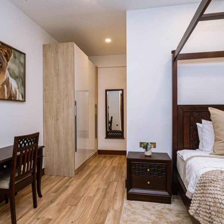 Furnished bedroom with wardrobe and study desk in a serviced 2 bedroom apartment in Parklands