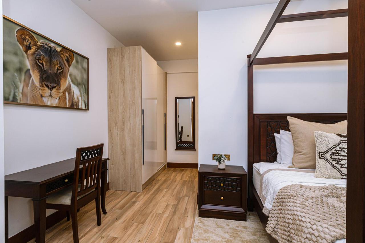 Furnished bedroom with wardrobe and study desk in a serviced 2 bedroom apartment in Parklands
