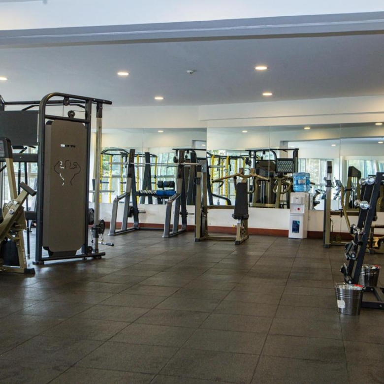 Modern gym with strength training equipment at serviced apartments in Parklands