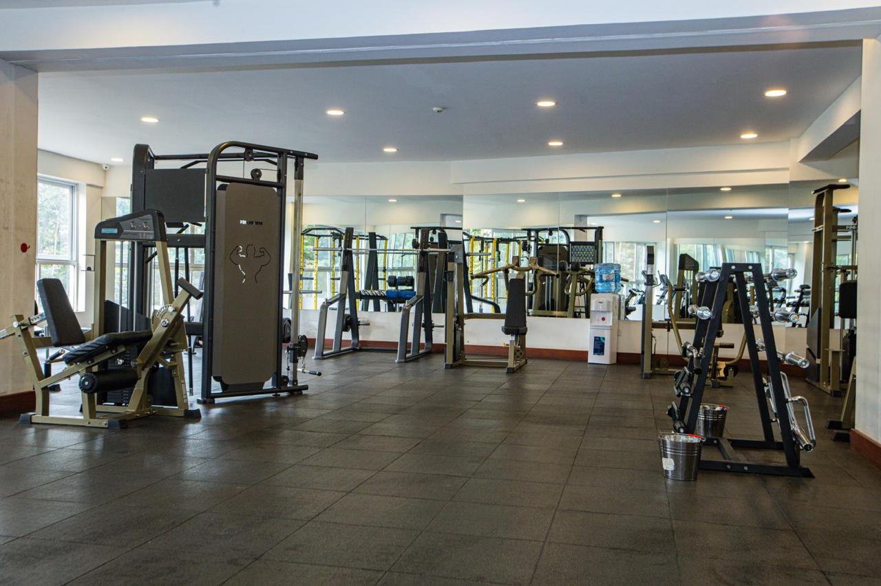 Modern gym with strength training equipment at serviced apartments in Parklands