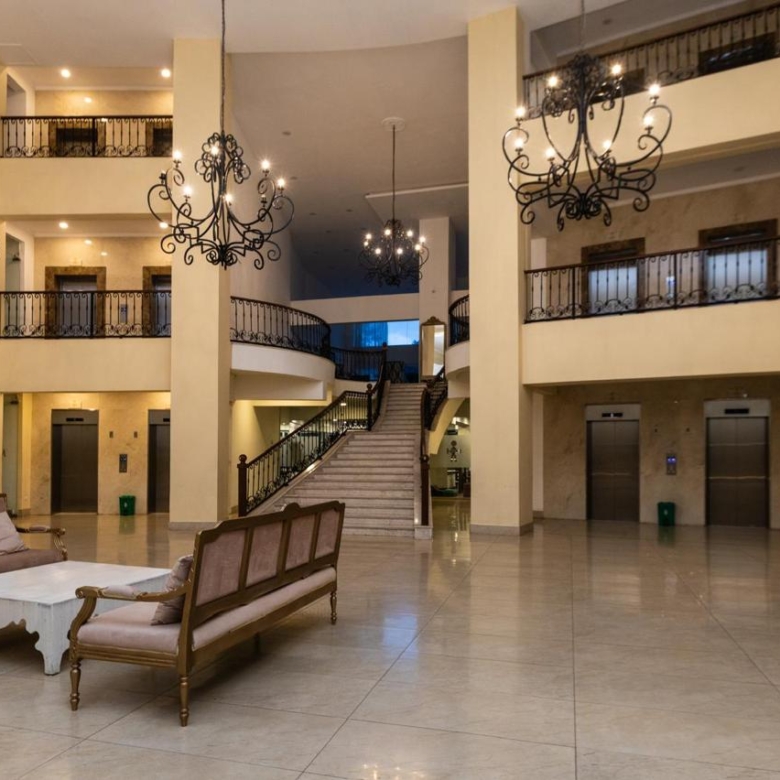 Serviced apartment lobby in Parklands with lounge seating, elevators and grand staircase
