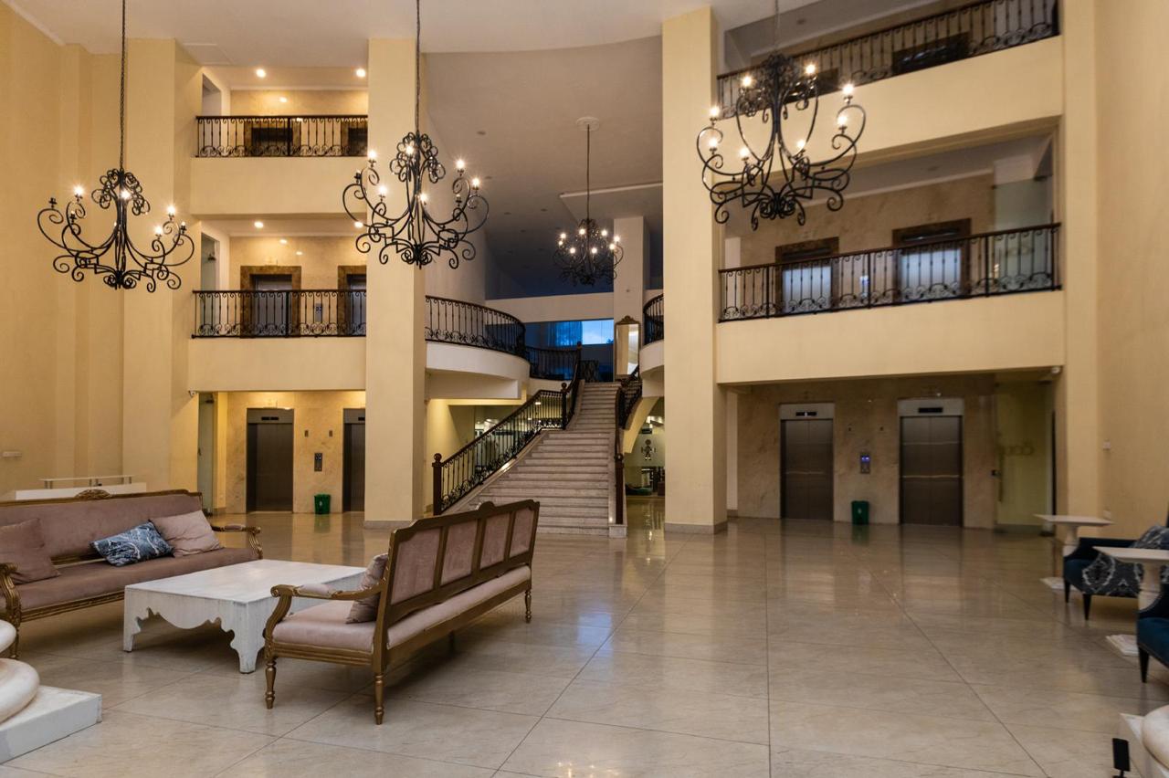 Serviced apartment lobby in Parklands with lounge seating, elevators and grand staircase