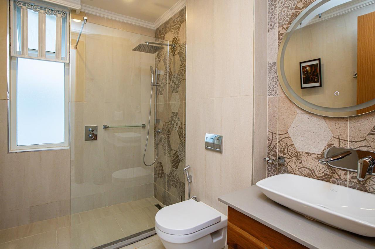 Modern bathroom with walk-in shower, vanity basin and patterned tiles in Parklands apartment