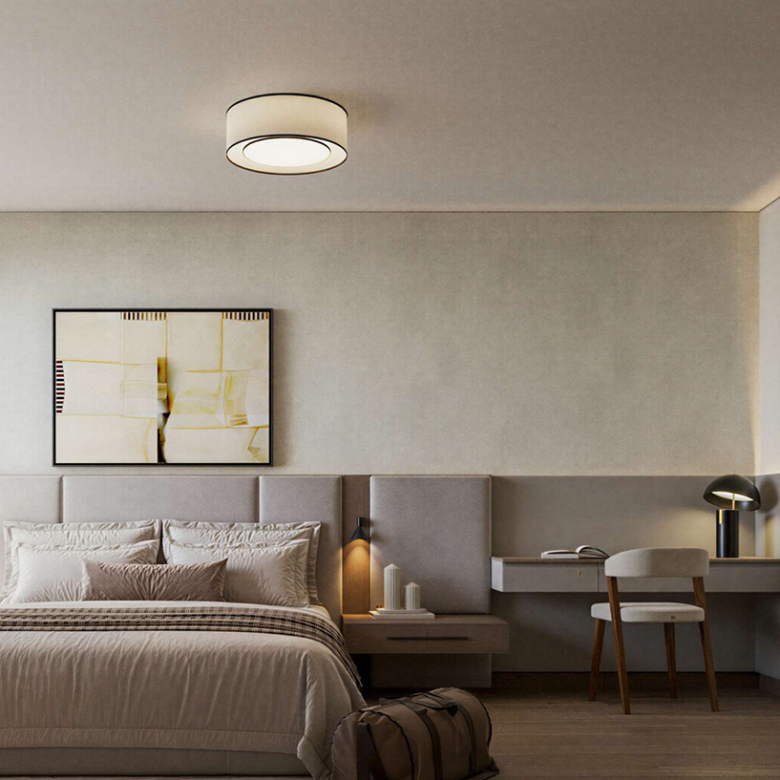 AERA Westlands modern bedroom featuring a padded upholstered headboard, neutral-toned bedding, bedside lighting and a built-in study desk.