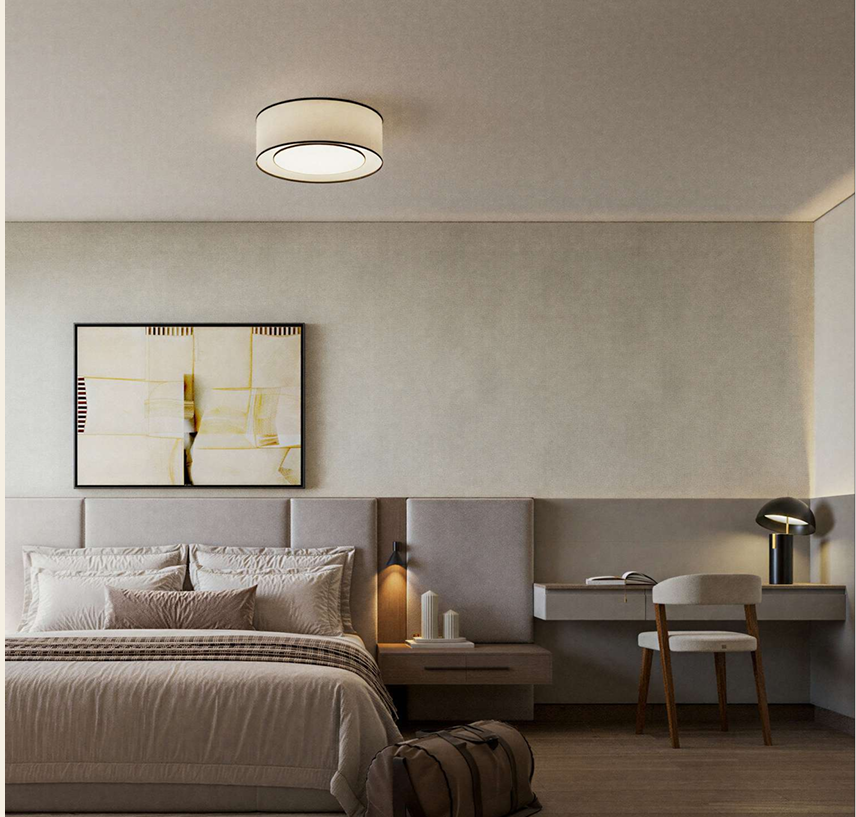 AERA Westlands modern bedroom featuring a padded upholstered headboard, neutral-toned bedding, bedside lighting and a built-in study desk.