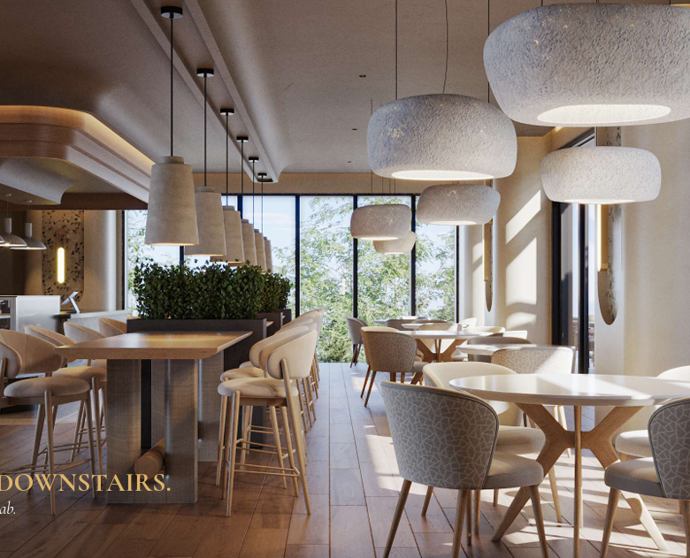 AERA Westlands coffee lounge featuring modern dining tables, upholstered chairs, pendant lighting and large glass windows overlooking greenery.