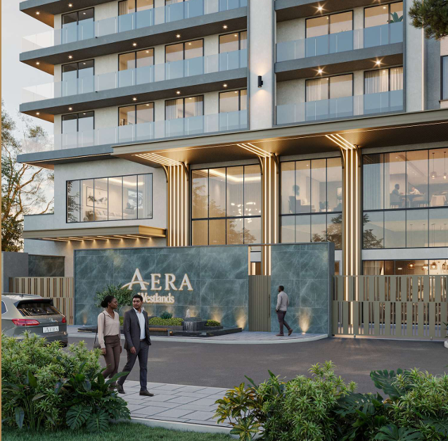 AERA Westlands apartment development entrance featuring a contemporary façade, illuminated architectural details, landscaped greenery and a secure gated entry.