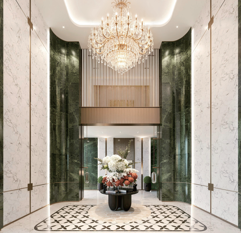 Avana Oasis Apartments grand reception lobby with crystal chandelier, marble wall finishes, decorative flooring and elegant entrance.