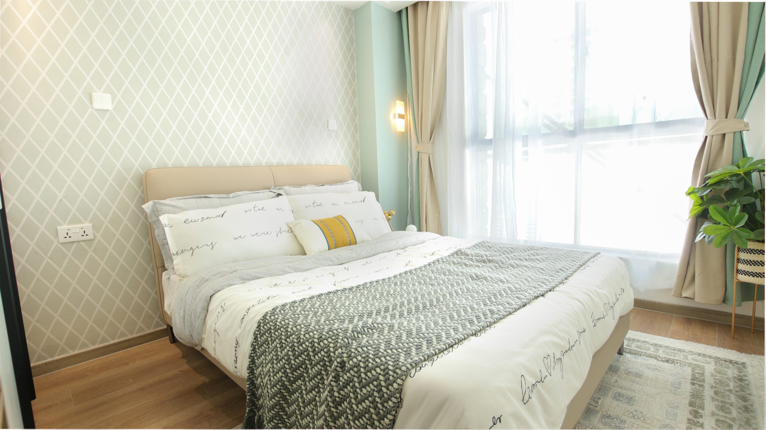 Himalaya Heights modern master bedroom with stylish furniture, elegant chandelier, decorative wallpaper and large windows in Kilimani.
