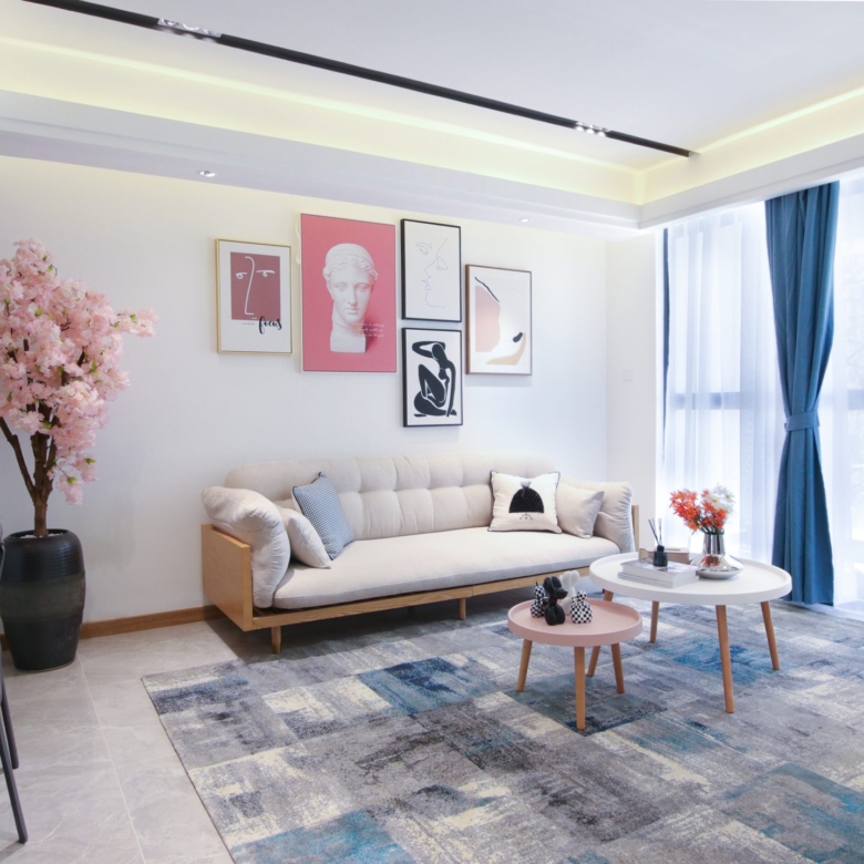 Himalaya Heights furnished living room with comfortable sofa, modern coffee tables, decorative wall art and large windows in Kilimani.
