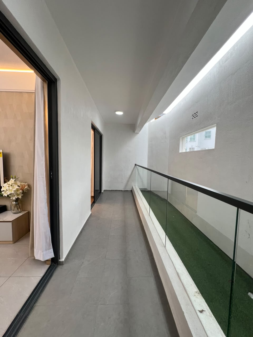 Longines Bay apartment balcony with glass railings and modern tiled flooring along Ngong Road, Nairobi.