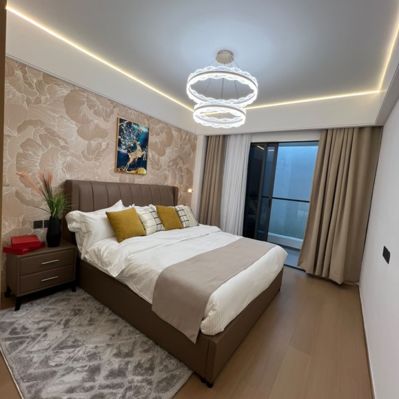 Longines Bay bedroom interior with upholstered bed, decorative wallpaper, chandelier and private balcony.