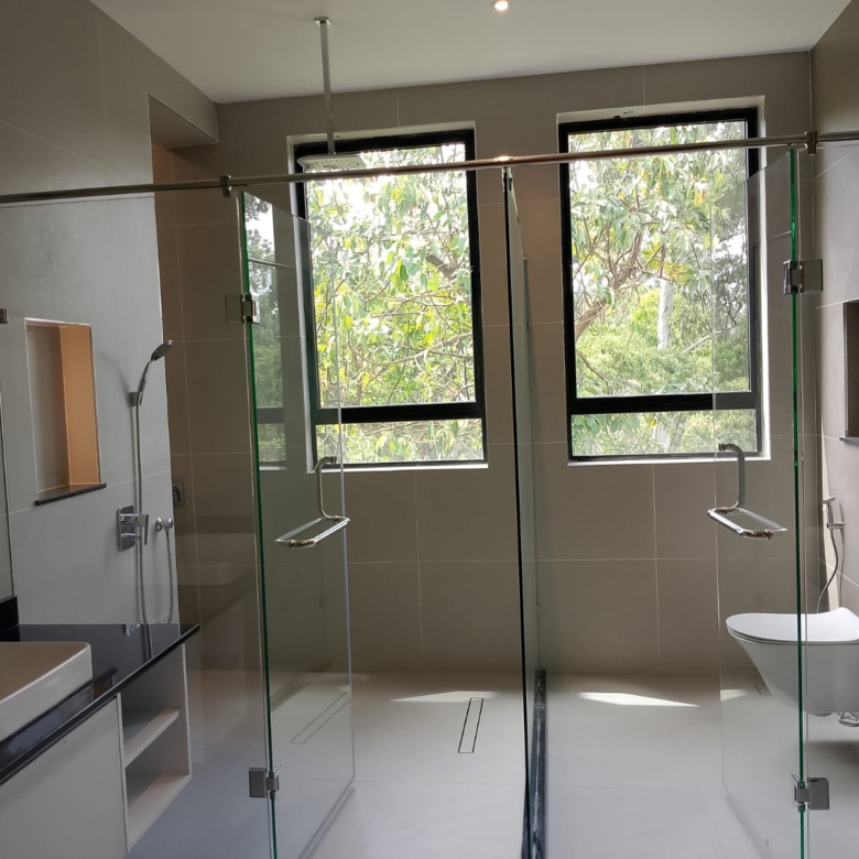 Radiant Villas luxury bathroom in Westlands Nairobi featuring glass shower enclosures, modern fittings and large windows.