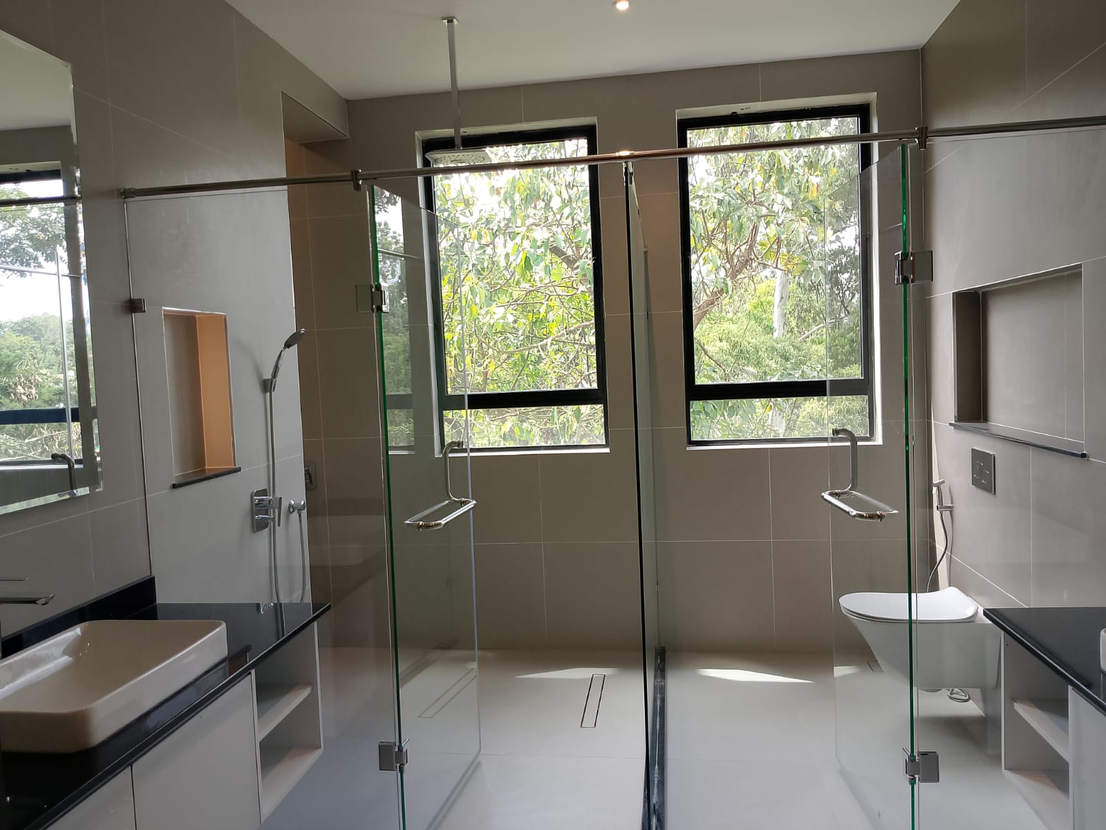 Radiant Villas luxury bathroom in Westlands Nairobi featuring glass shower enclosures, modern fittings and large windows.