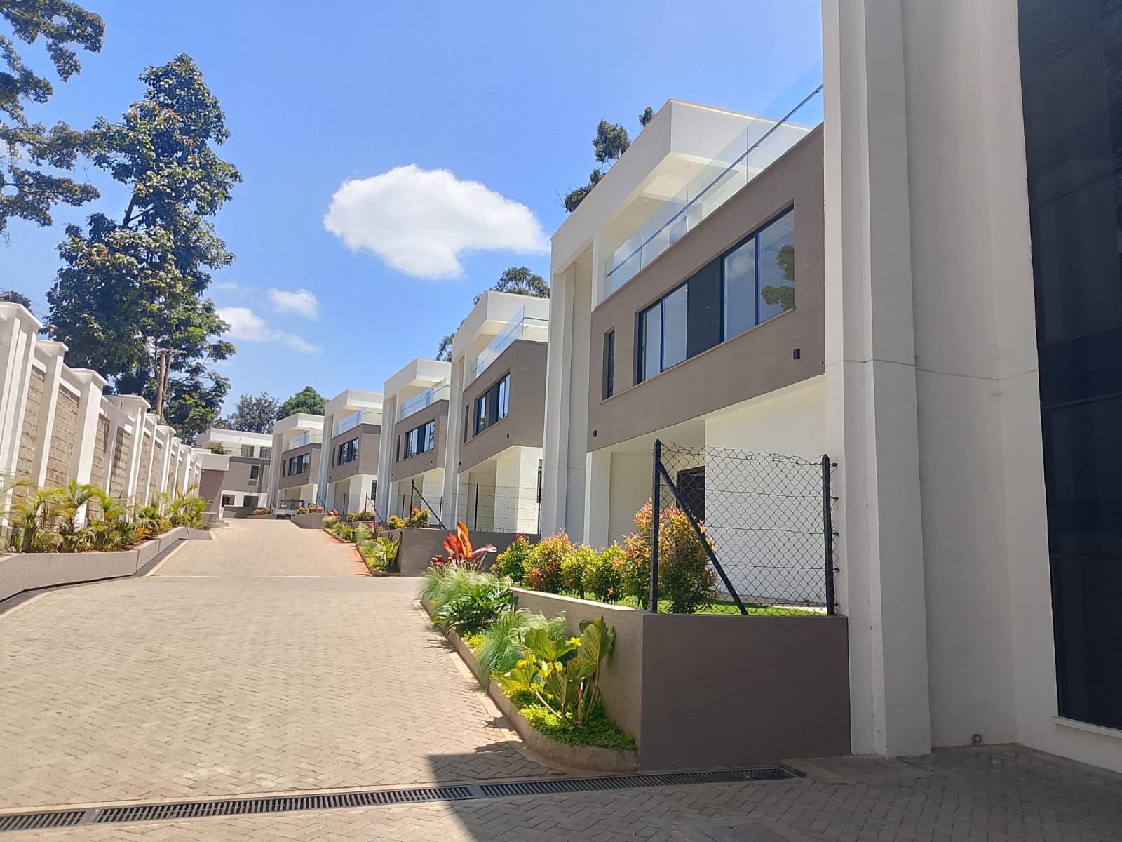 Radiant Villas gated community in Westlands Peponi Road featuring modern luxury villas, landscaped gardens and paved driveway.