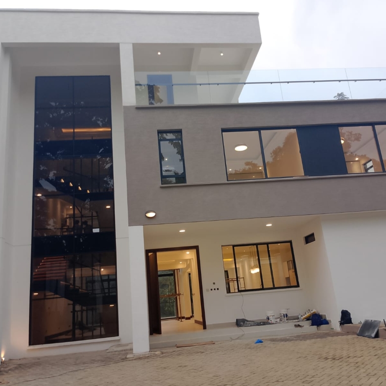 Radiant Villas luxury 6 bedroom house entrance in Westlands Nairobi featuring modern facade, large windows and private driveway.