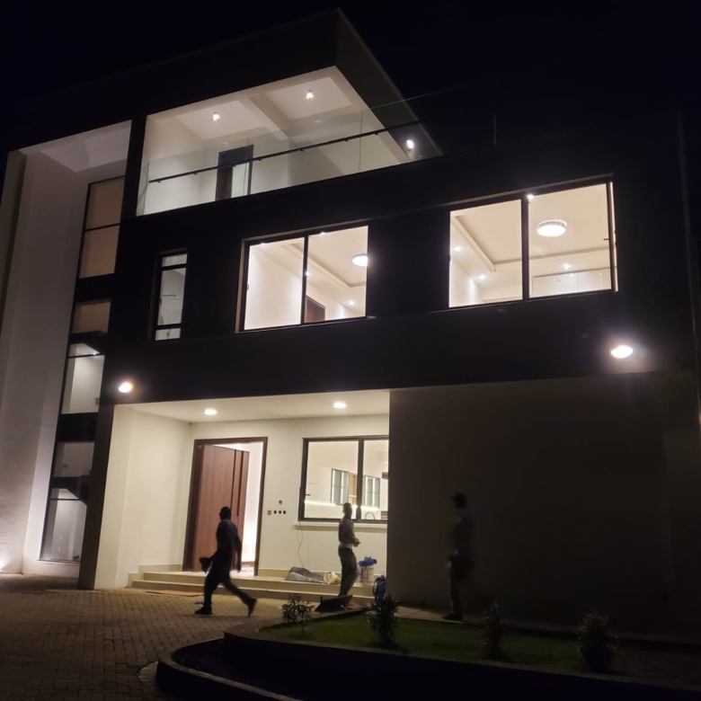 Radiant Villas luxury villa exterior at night in Peponi Road Westlands featuring illuminated windows and modern architectural design.