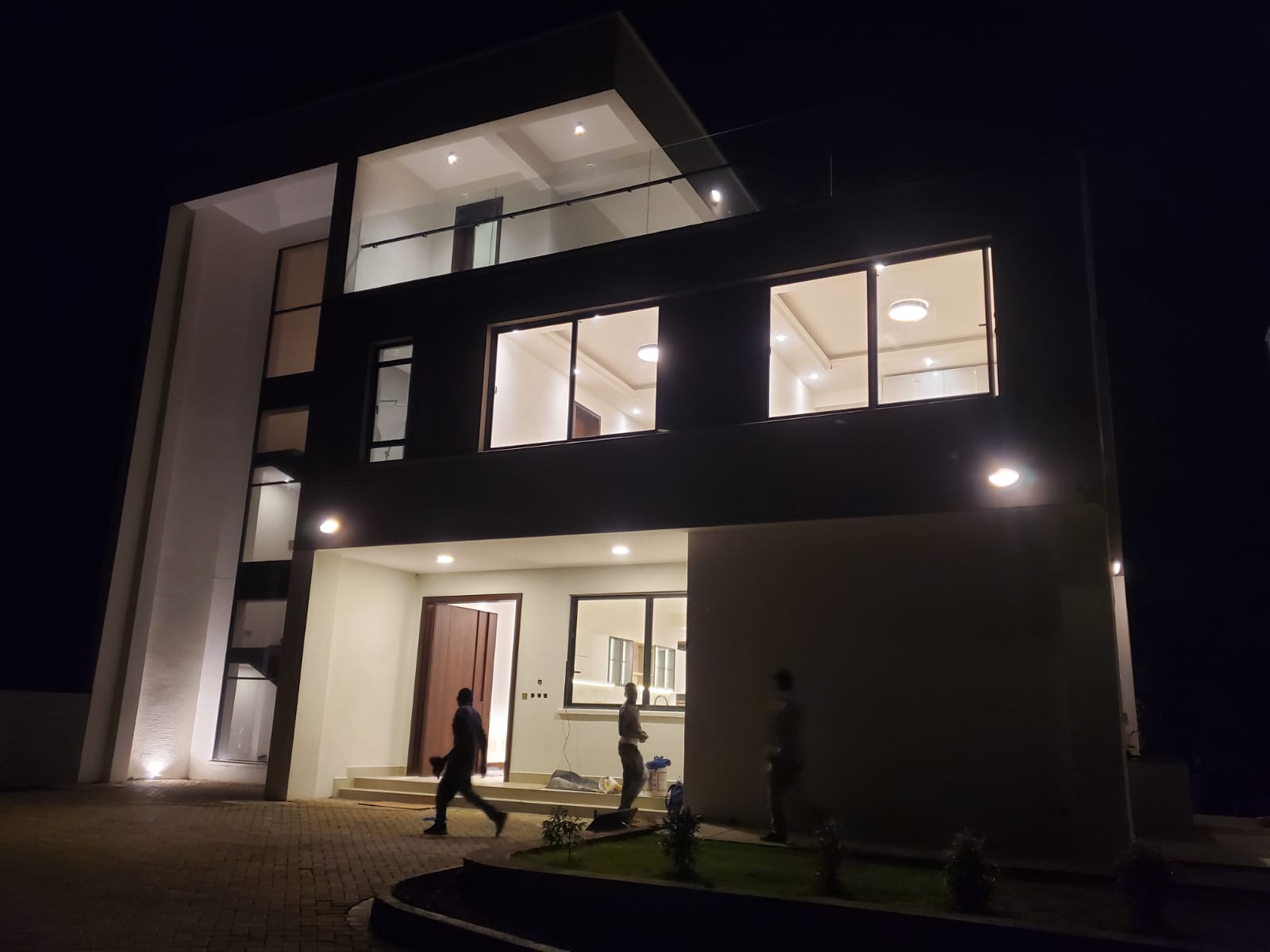 Radiant Villas luxury villa exterior at night in Peponi Road Westlands featuring illuminated windows and modern architectural design.
