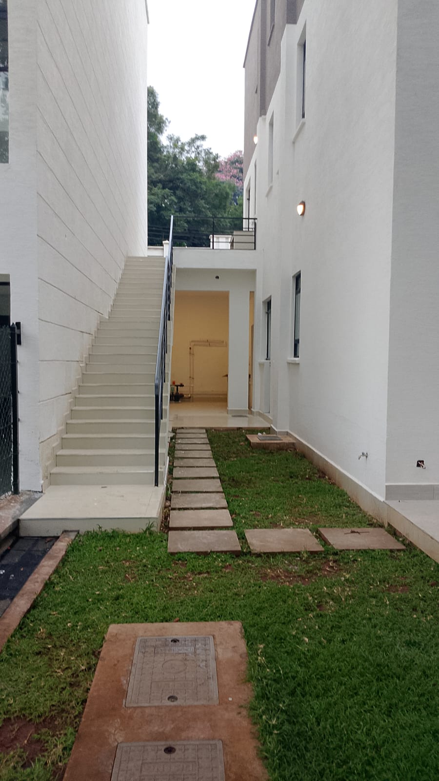 Radiant Villas exterior pathway in Westlands Nairobi featuring private garden, paved walkway and outdoor staircase.